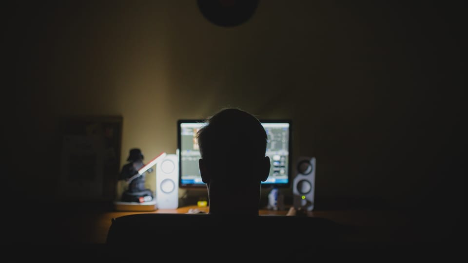 man on computer at night